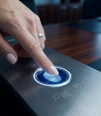 Woman_pressing_fingerprint_scanner_202605061615